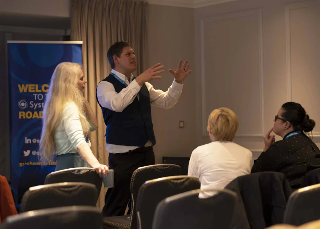 People talking at SystemsLink roadshow in 2023