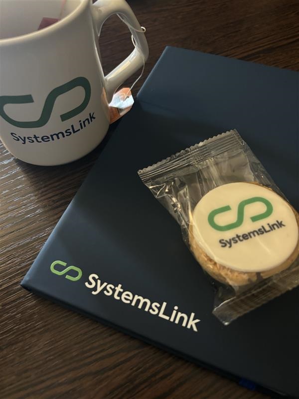 SystemsLink cup, notebook and biscuit