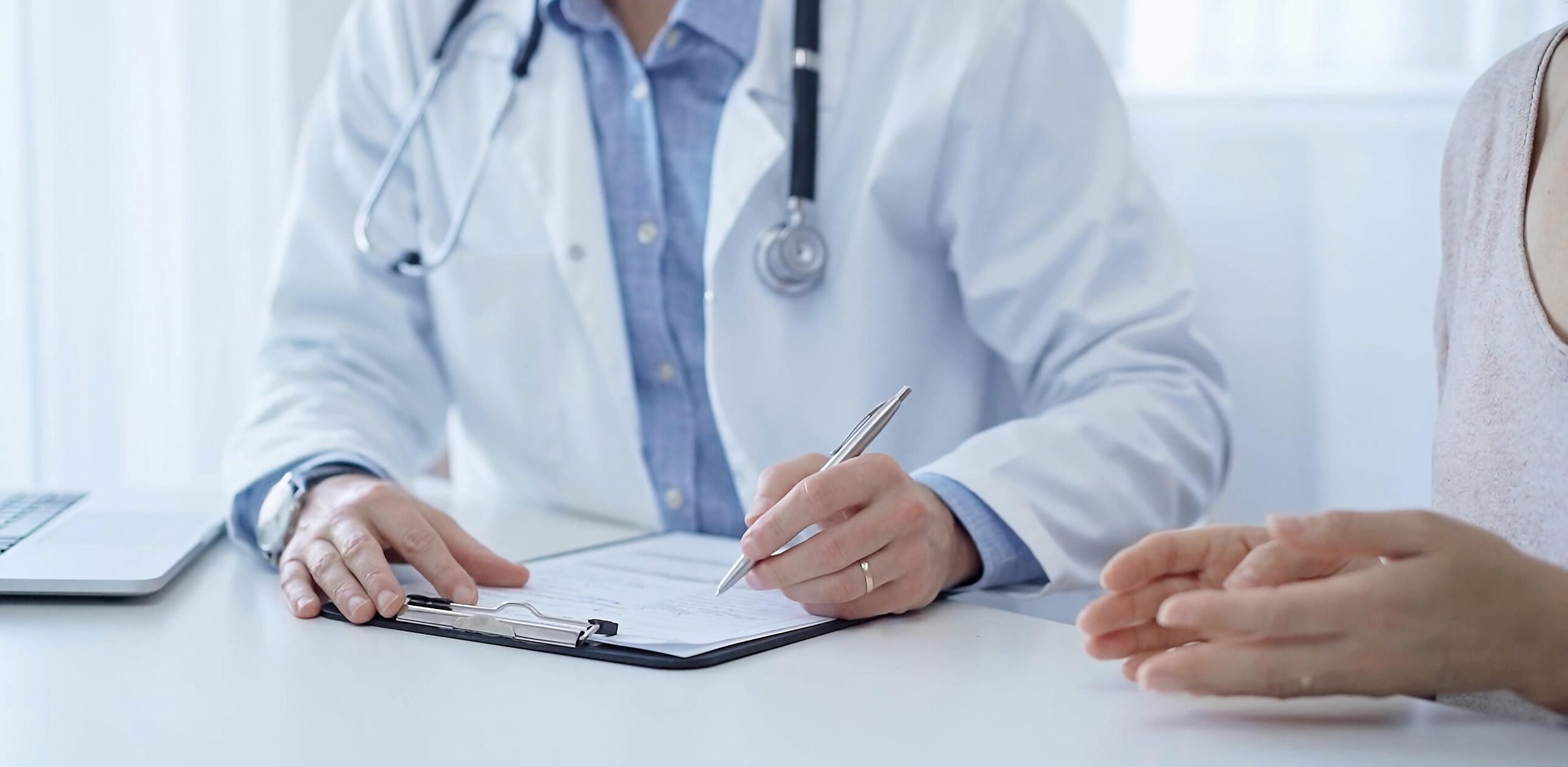 Close up of doctor holding a pen and paper